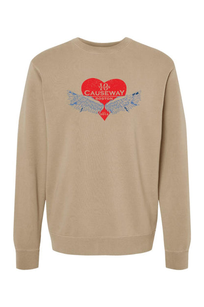 Tan pigment-dyed crewneck sweatshirt featuring a red heart graphic with blue wings and Causeway 10th anniversary text.