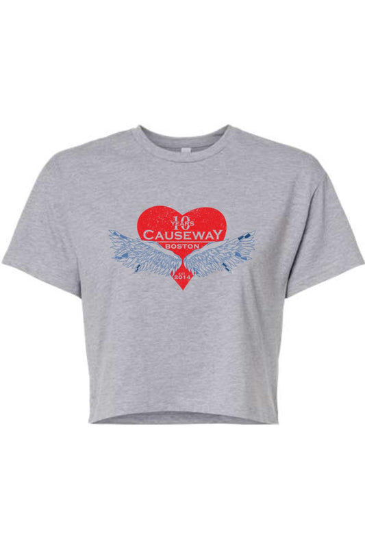 Grey women's crop top featuring a red heart graphic with blue angel wings and Causeway 10th anniversary text.