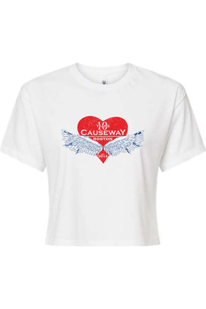 White women's crop top featuring a red heart graphic with blue wings and Causeway 10th anniversary text.