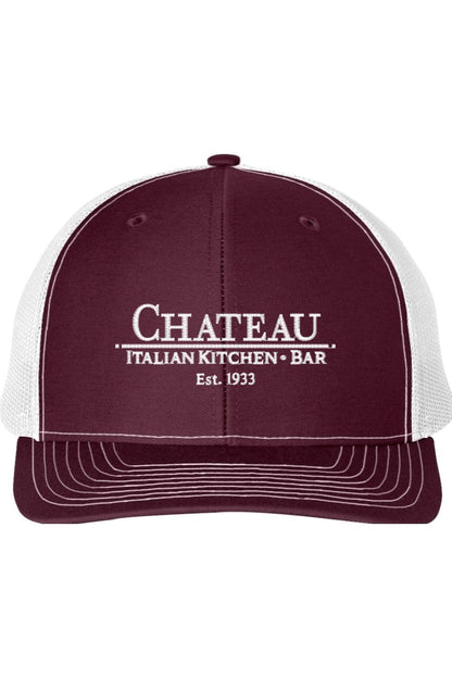 Maroon and white trucker cap with Chateau Italian Kitchen + Bar logo, structured six-panel design, and mesh back.