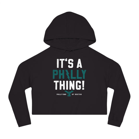 Black cropped graphic hoodie featuring It's A Philly Thing text with a bell icon in white and teal print.