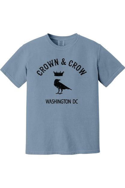 Blue garment-dyed unisex t-shirt featuring a black Crown & Crow logo with a crow and crown graphic and Washington DC text.