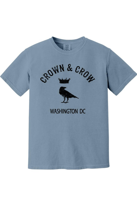 Blue garment-dyed unisex t-shirt featuring a black Crown & Crow logo with a crow and crown graphic and Washington DC text.