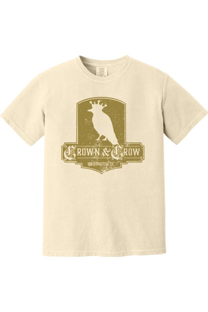 Cream-colored garment-dyed cotton t-shirt featuring a distressed gold Crown & Crow logo graphic on the chest.