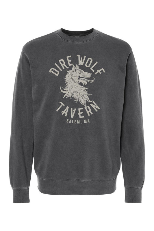 Charcoal pigment-dyed crewneck sweatshirt featuring a vintage-style Dire Wolf Tavern logo graphic on the chest.