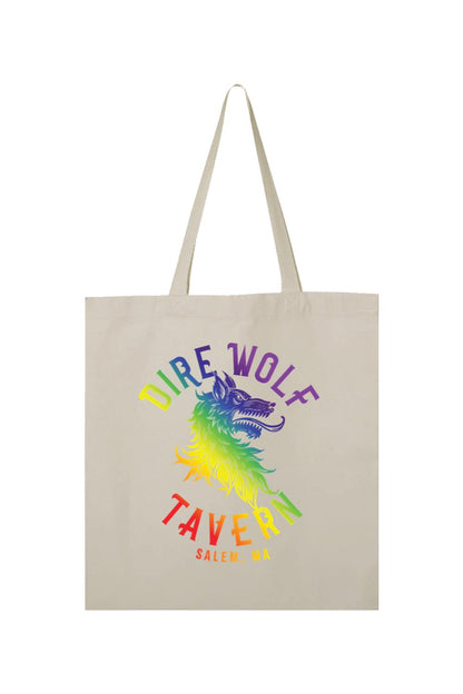 Natural canvas tote bag featuring a rainbow-colored Dire Wolf Tavern logo and Salem, MA text on the front.