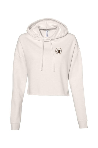 Off-white lightweight cropped hoodie with a small circular logo on the chest and matching drawstring hood.