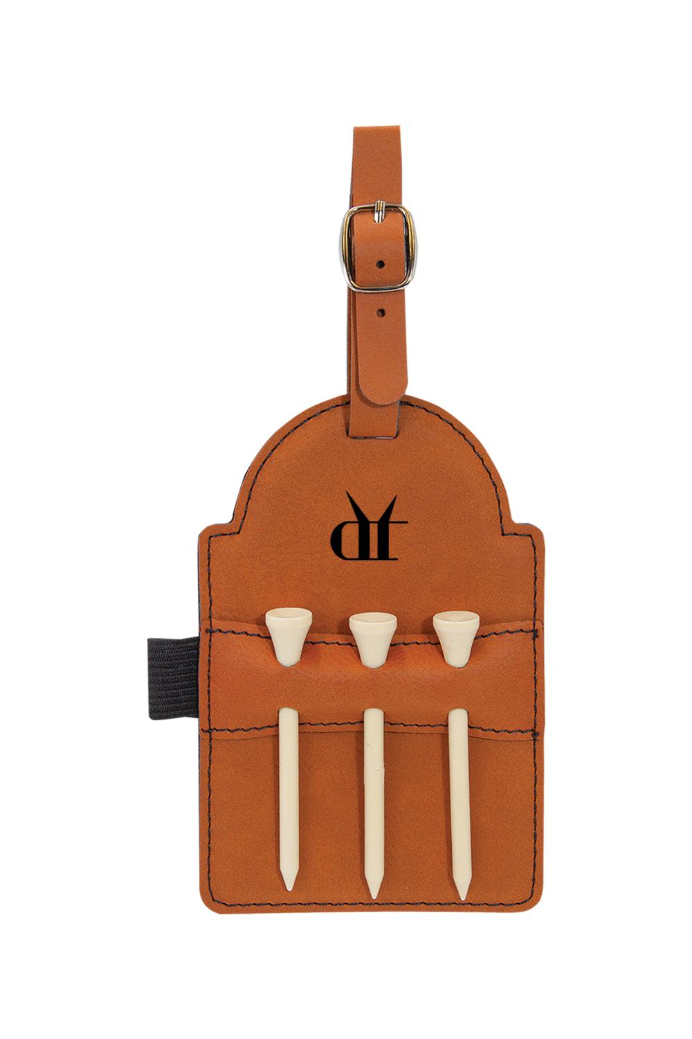 Tan leatherette golf bag tag with Drink That logo, buckle strap, and three white wooden tees in stitched pockets.