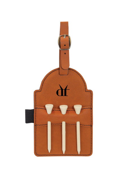 Tan leatherette golf bag tag with Drink That logo, buckle strap, and three white wooden tees in stitched pockets.