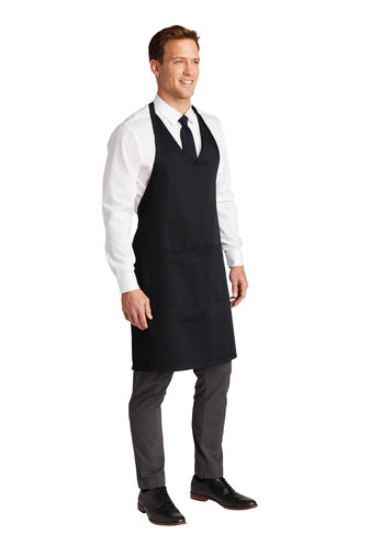 Black poly-cotton tuxedo apron with an adjustable neck strap and two front pockets worn by a man.