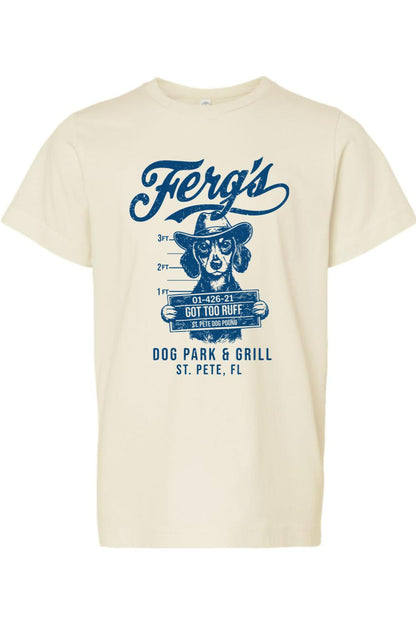 Cream-colored kids' cotton t-shirt featuring a blue graphic of a dog in a cowboy hat holding a mugshot sign.