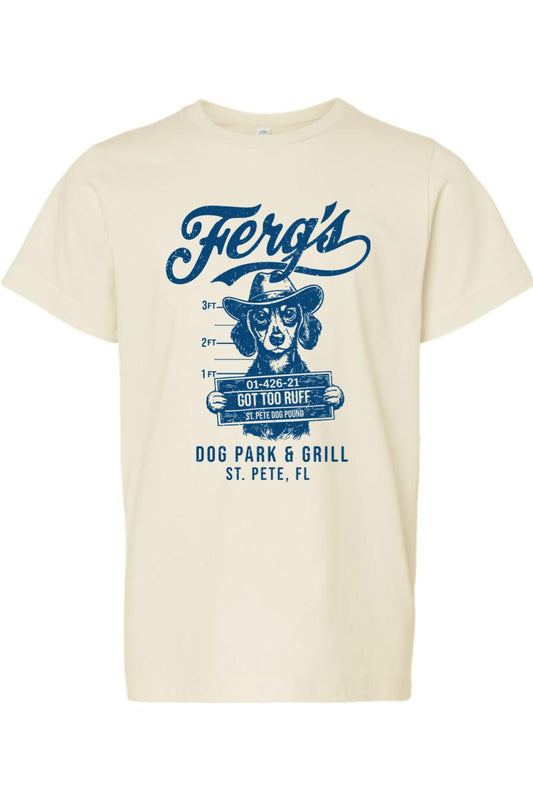 Cream-colored kids' cotton t-shirt featuring a blue graphic of a dog in a cowboy hat holding a mugshot sign.