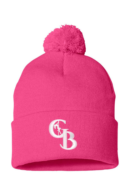 Bright pink 12-inch knit beanie with a matching pom-pom and white embroidered GB logo on the folded cuff.
