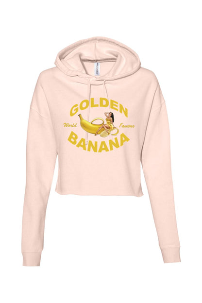 Light pink cropped hooded sweatshirt featuring a yellow Golden Banana graphic with a pin-up style woman.