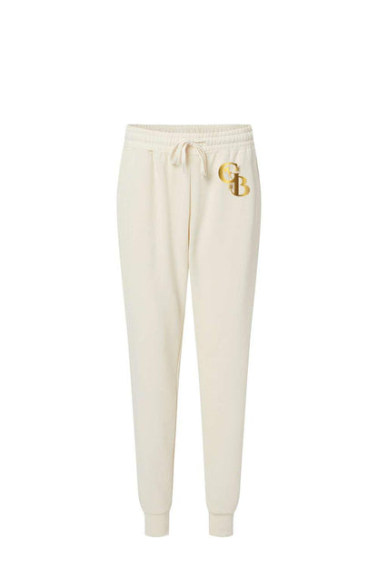 Cream-colored women's fleece sweatpants with a drawstring waist and a metallic gold GB logo on the left hip.