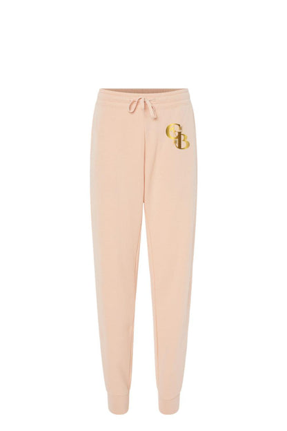 Light peach Golden Banana women's fleece sweatpants with a drawstring waist and metallic gold GB logo on the hip.