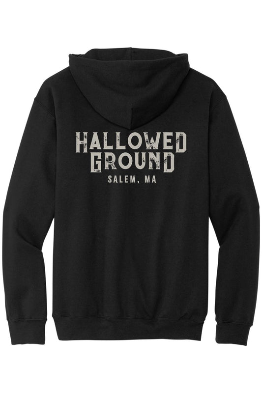 Black zip-up hoodie featuring Hallowed Ground Salem, MA distressed white text on the back.