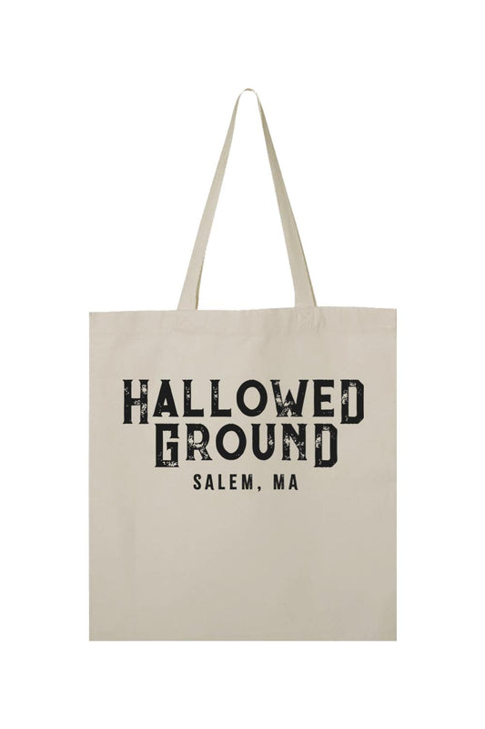Natural cotton canvas tote bag featuring black Hallowed Ground Salem, MA text in a distressed, vintage-style font.