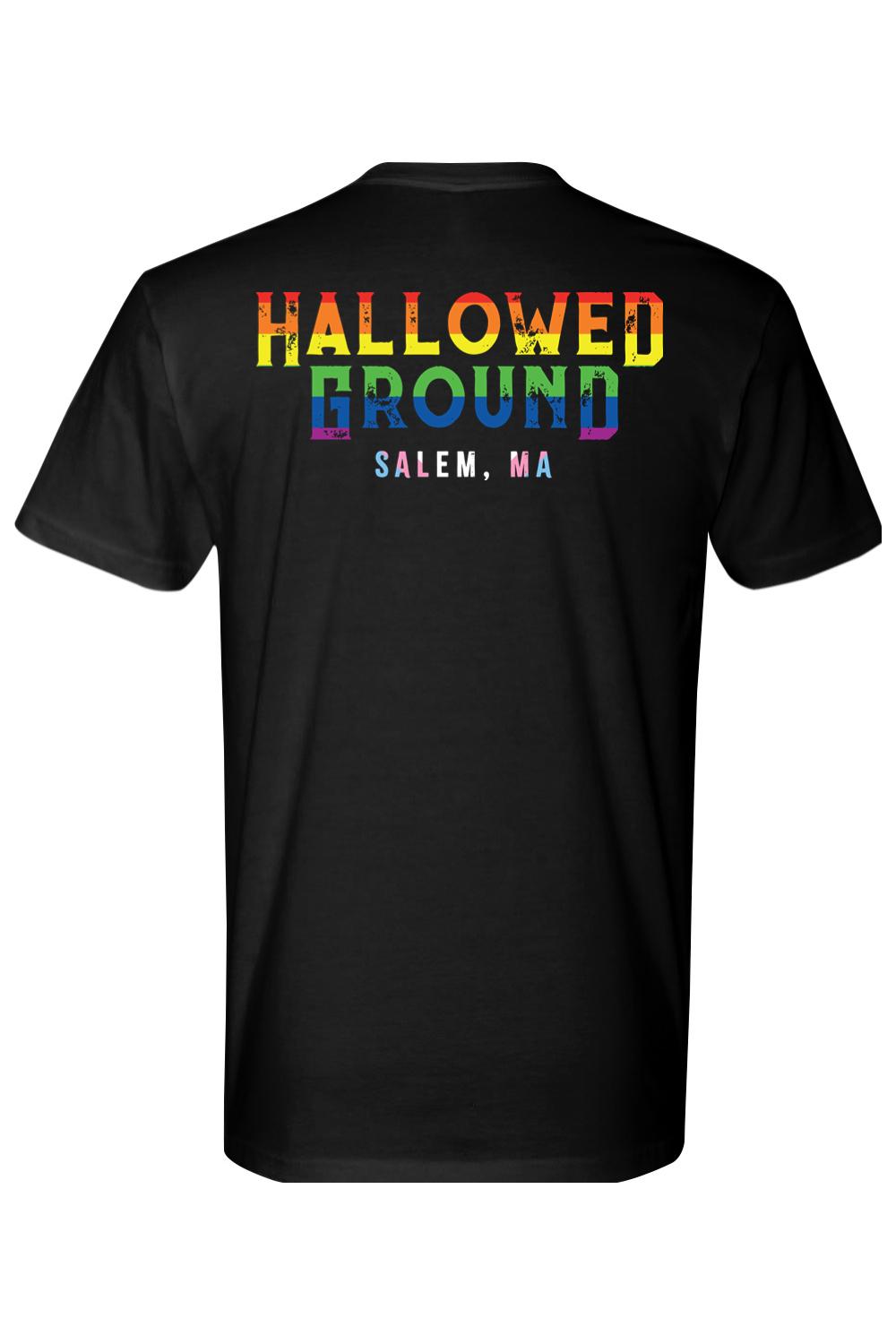 Black cotton t-shirt featuring Hallowed Ground Salem, MA text in a distressed rainbow pride gradient design.