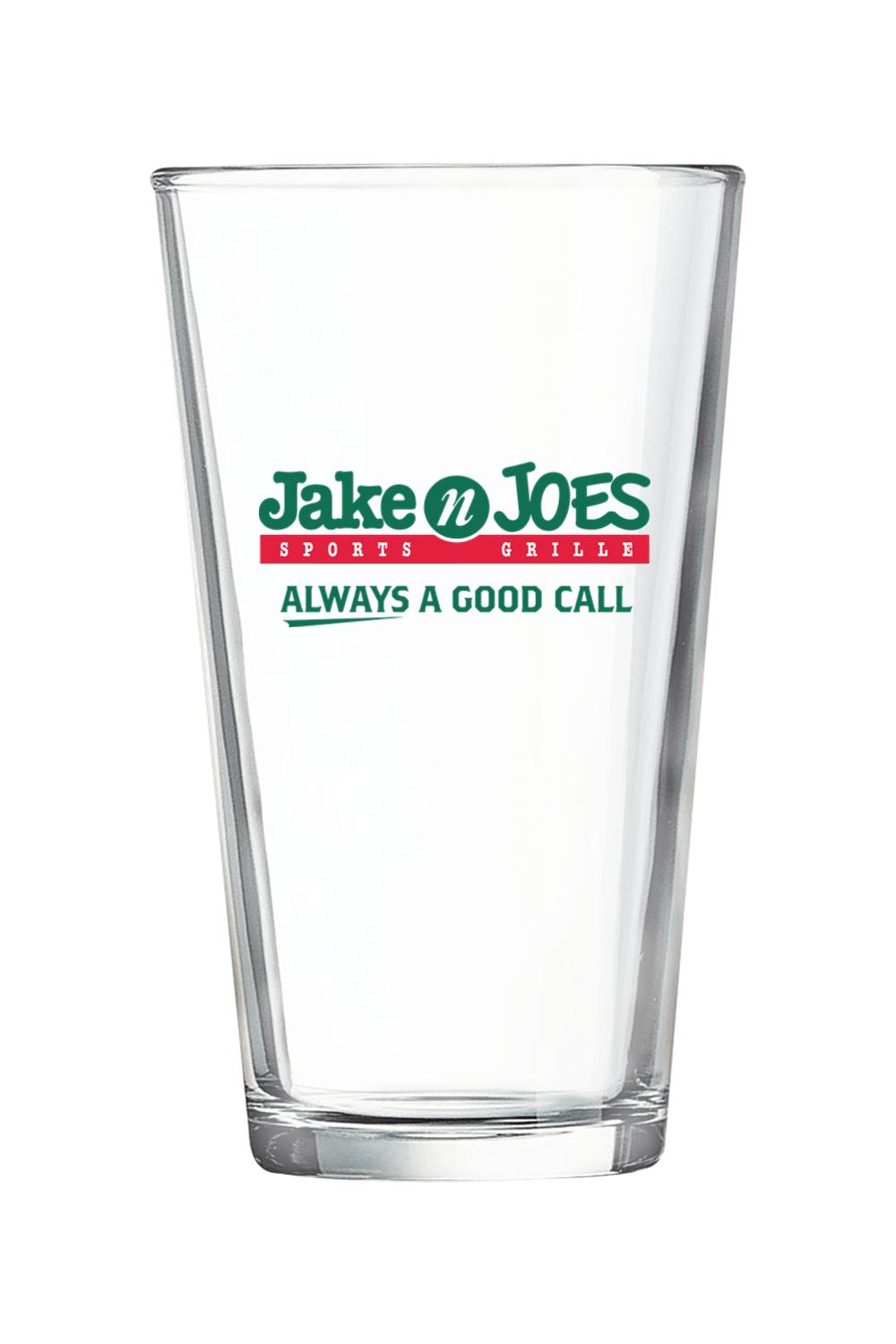 Clear 16 oz. pint mixing glass featuring the green and red Jake n JOES Sports Grille logo on the front.