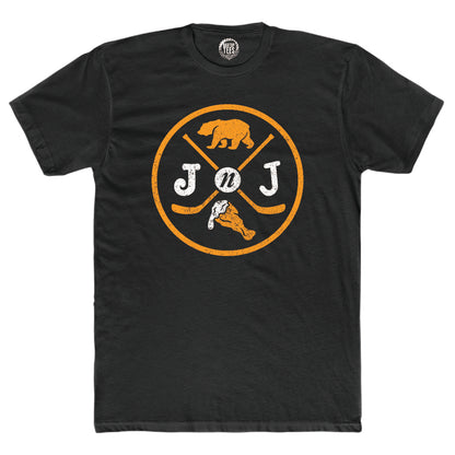 Black cotton crew neck t-shirt featuring a Jake n JOES bear, wing, and hockey stick graphic logo.