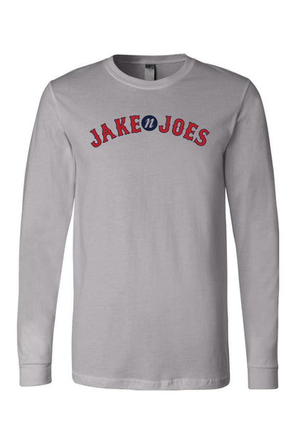 Light gray long-sleeve cotton t-shirt featuring a red and blue Jake n JOES baseball-style logo on the chest.