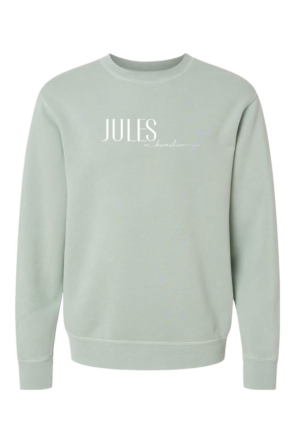 Sage green pigment-dyed crewneck sweatshirt with white Jules on Devonshire logo text on the chest.