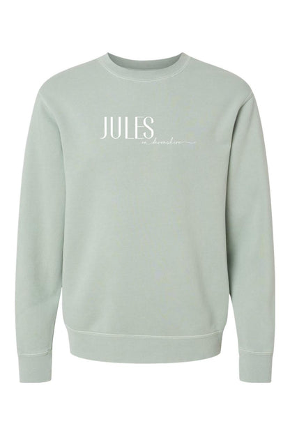 Sage green pigment-dyed crewneck sweatshirt with white Jules on Devonshire logo text on the chest.