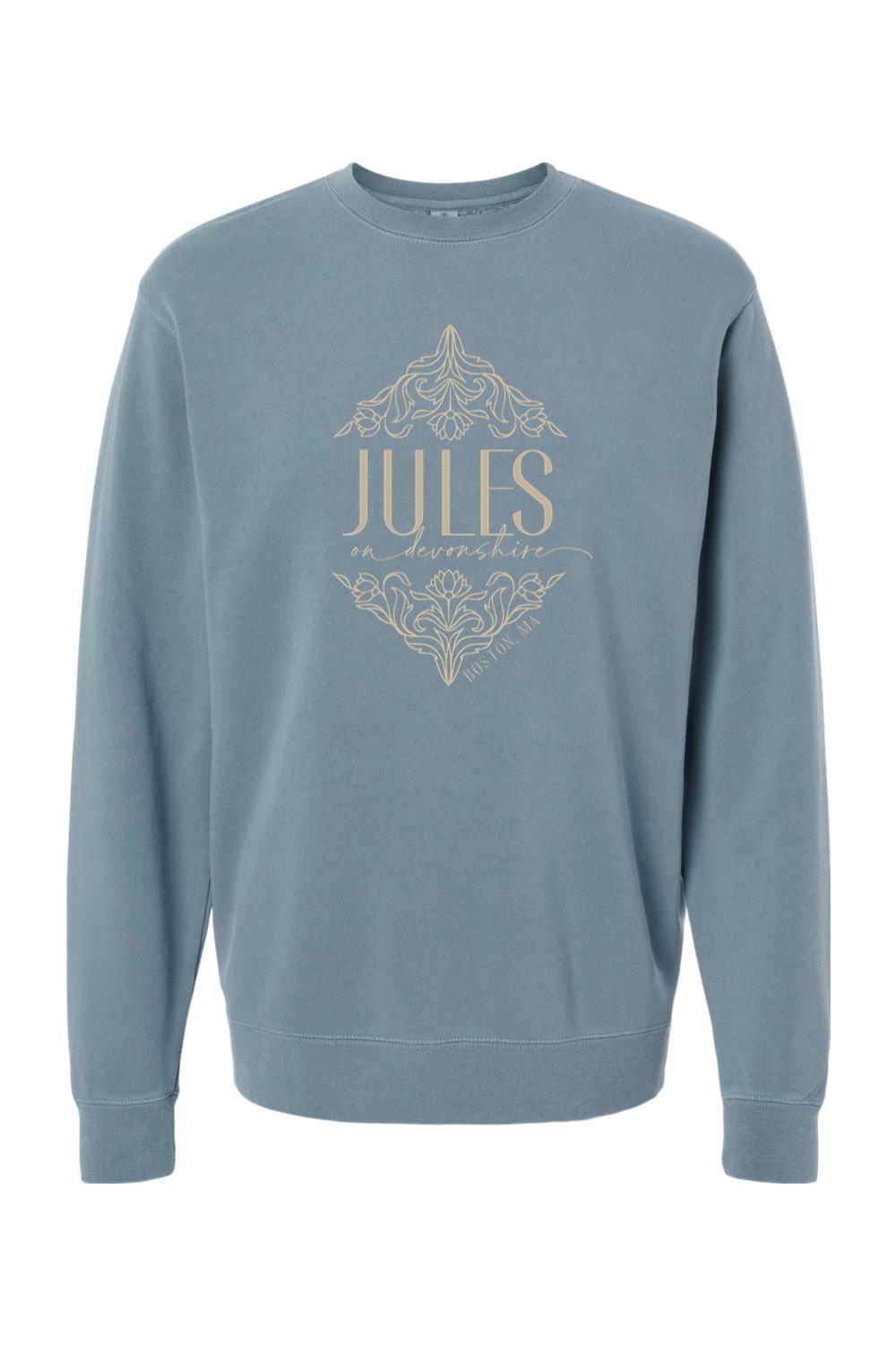 Blue pigment-dyed crewneck sweatshirt featuring a tan Jules on Devonshire Boston, MA graphic with floral accents.
