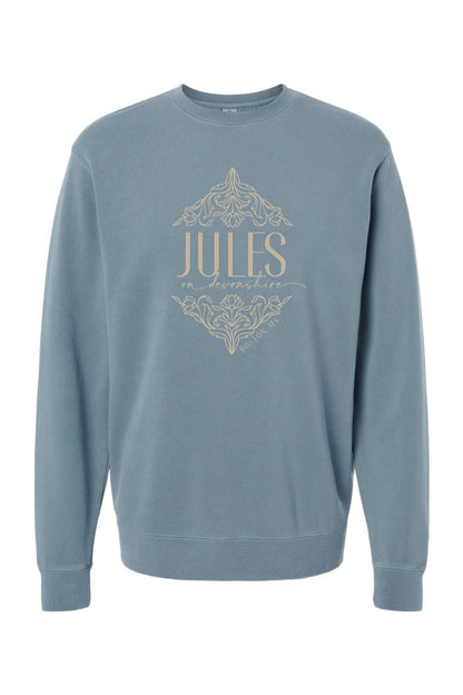 Blue pigment-dyed crewneck sweatshirt featuring a tan Jules on Devonshire Boston, MA graphic with floral accents.
