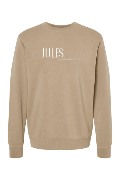 Tan pigment-dyed crewneck sweatshirt with white Jules on Devonshire logo text on the chest.