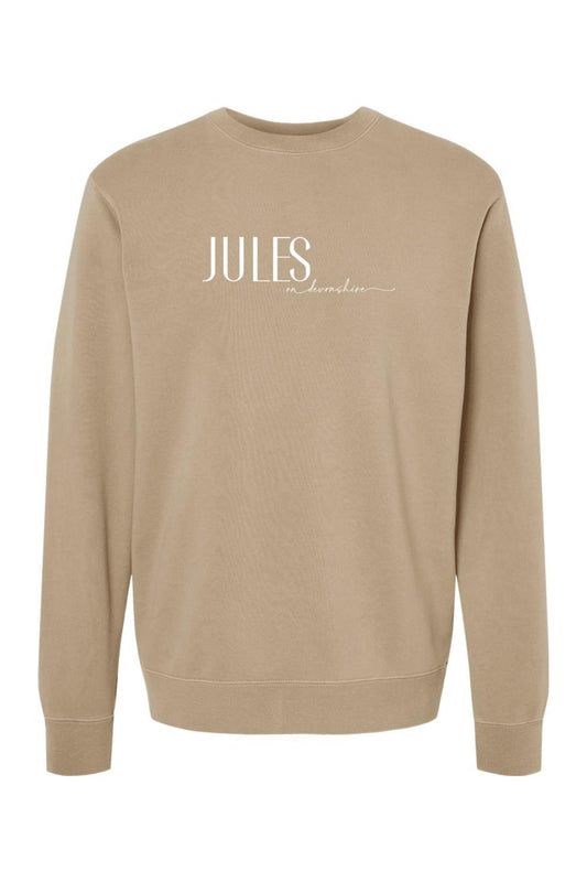 Tan pigment-dyed crewneck sweatshirt with white Jules on Devonshire logo text on the chest.