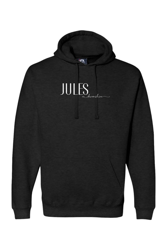 Black premium hoodie featuring a white Jules on Devonshire logo, drawstring hood, and front kangaroo pocket.