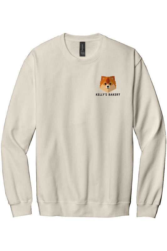 Cream-colored fleece crewneck sweatshirt featuring a small geometric dog logo and Kelly's Bakery text on the chest.
