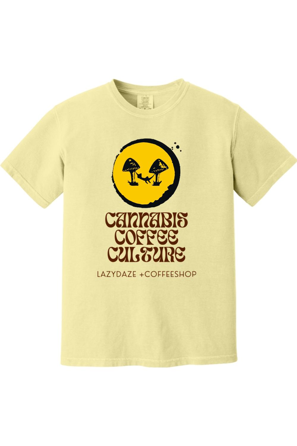 Pale yellow garment-dyed cotton t-shirt featuring a mushroom and hammock graphic with Cannabis Coffee Culture text.