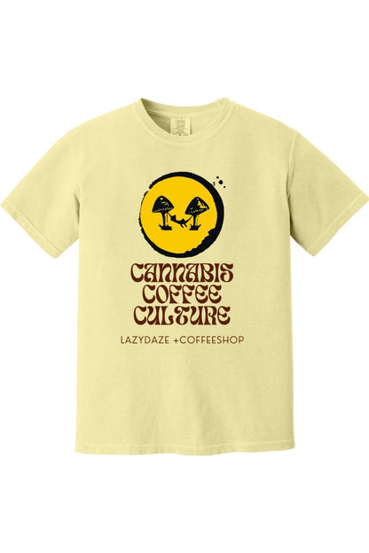 Pale yellow garment-dyed cotton t-shirt featuring a mushroom and hammock graphic with Cannabis Coffee Culture text.