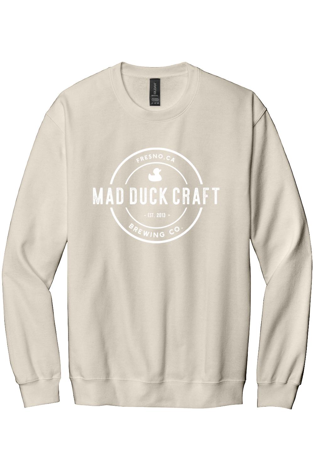 Beige crewneck sweatshirt featuring a white Mad Duck Craft Brewing Co. logo printed on the front chest.