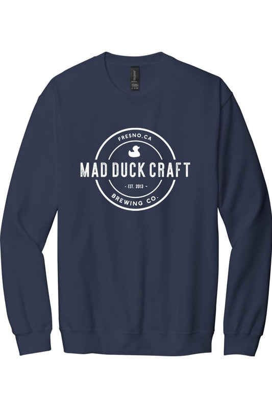 Navy blue crewneck sweatshirt featuring a white circular Mad Duck Craft Brewing Co. logo on the chest.