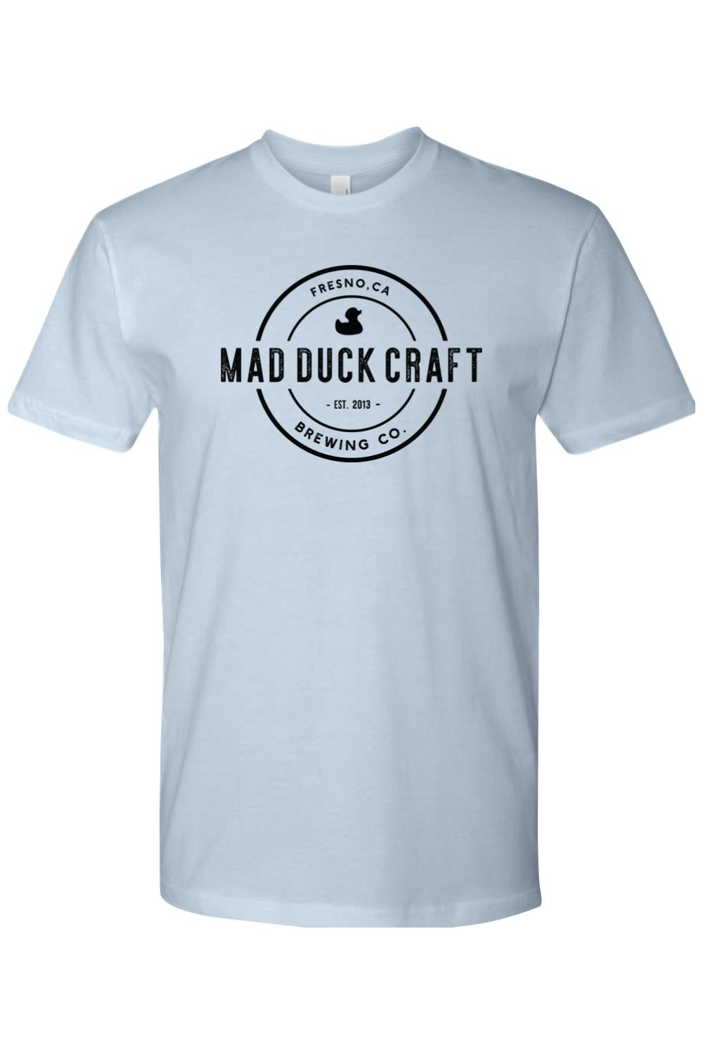 Light blue cotton crew neck t-shirt featuring a black Mad Duck Craft Brewing Co. circular logo on the chest.