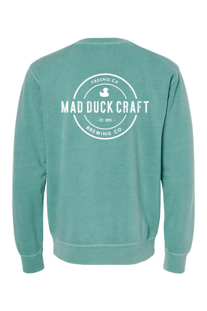Seafoam green pigment-dyed crewneck sweatshirt featuring a white Mad Duck Craft Brewing Co. logo on the back.