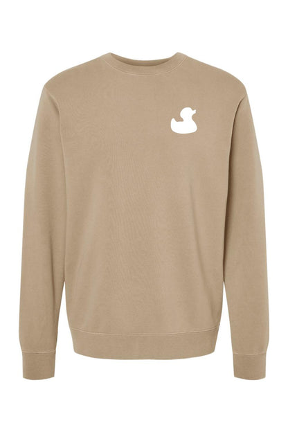 Tan pigment-dyed men's crewneck sweatshirt featuring a white rubber duck logo on the left chest.