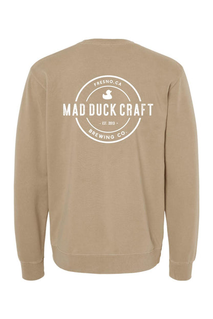 Tan pigment-dyed crewneck sweatshirt featuring a white Mad Duck Craft Brewing Co. logo on the back.