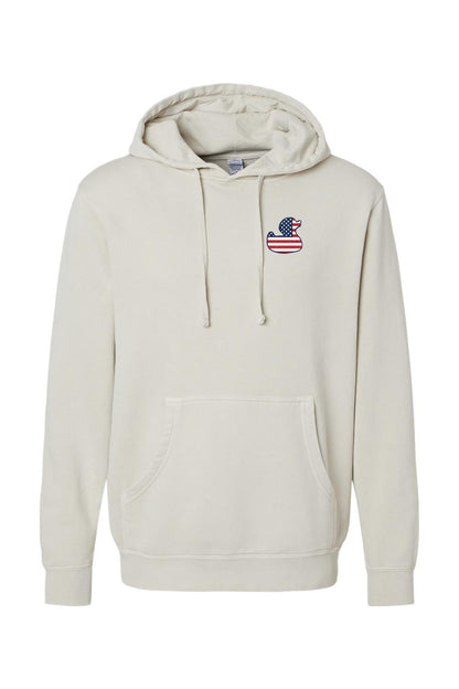 Beige pigment-dyed hoodie with a red, white, and blue American flag duck logo on the chest and a front pouch pocket.