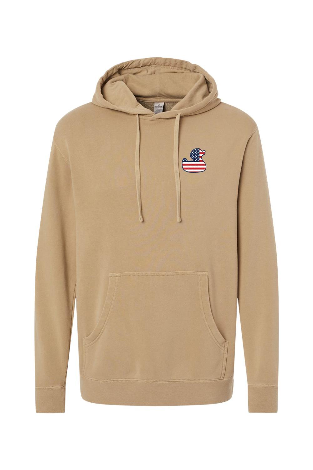 Tan pigment-dyed hoodie with a red, white, and blue American flag duck logo on the chest and a front pouch pocket.