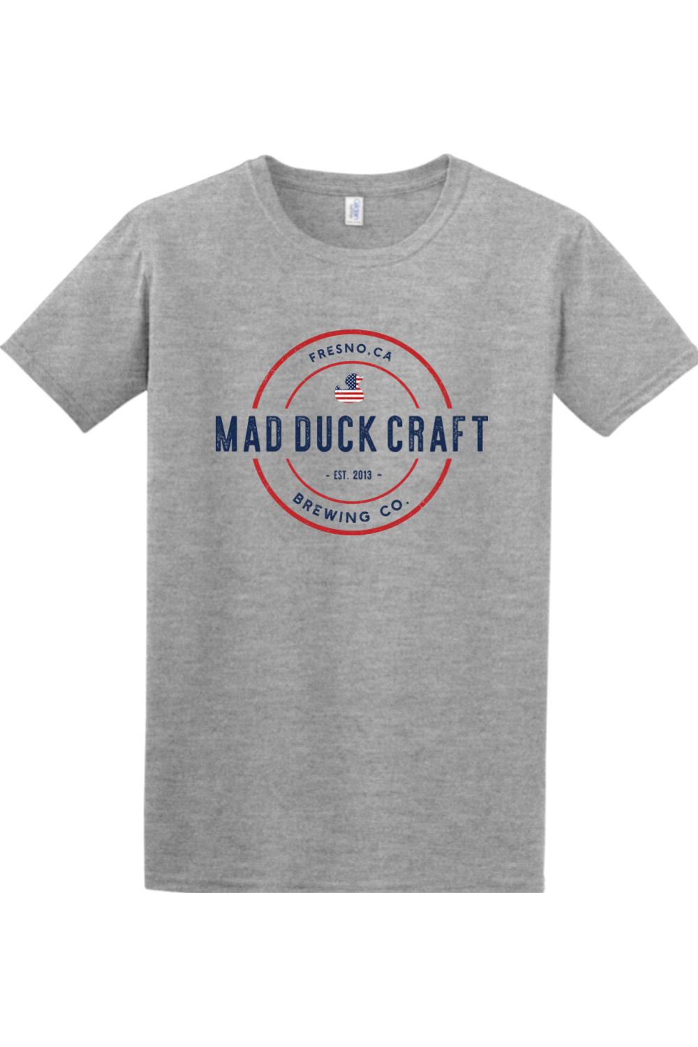 Heather gray crewneck t-shirt featuring a red, white, and blue Mad Duck Craft Brewing logo on the chest.