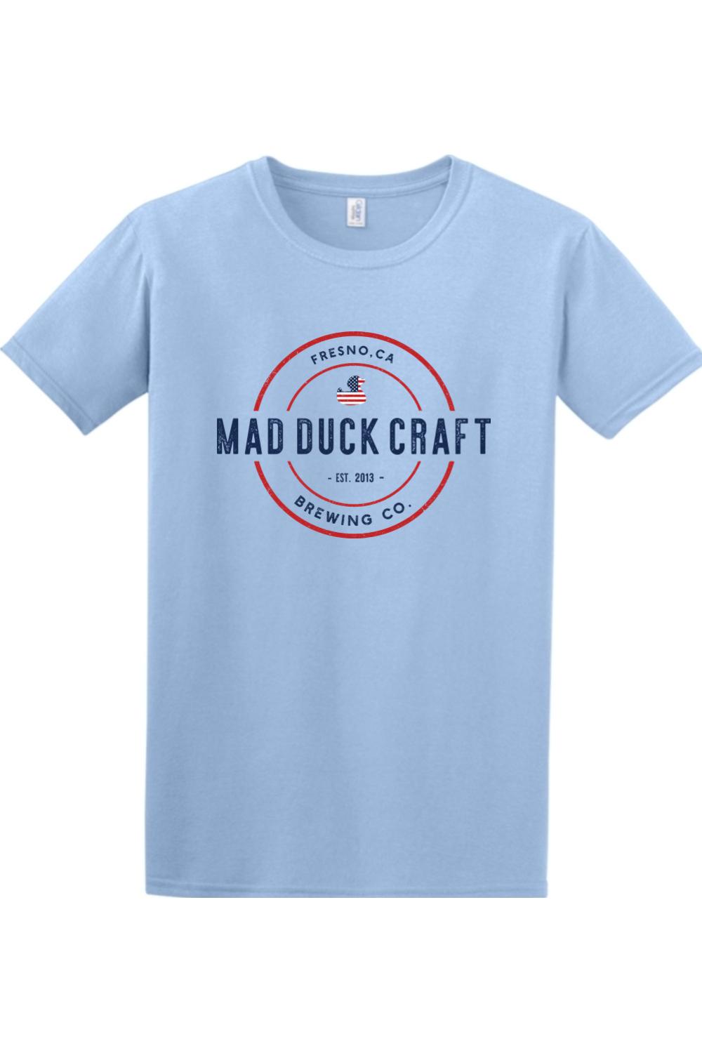 Light blue cotton t-shirt featuring a red, white, and blue Mad Duck Craft Brewing Co. logo on the chest.