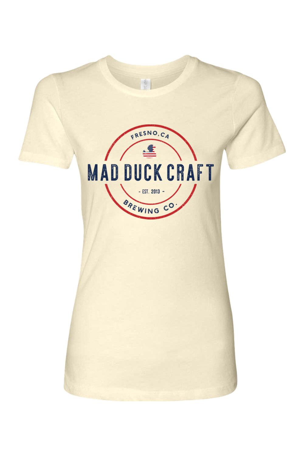 Cream-colored women's cotton t-shirt featuring a red, white, and blue Mad Duck Craft Brewing Co. logo graphic.
