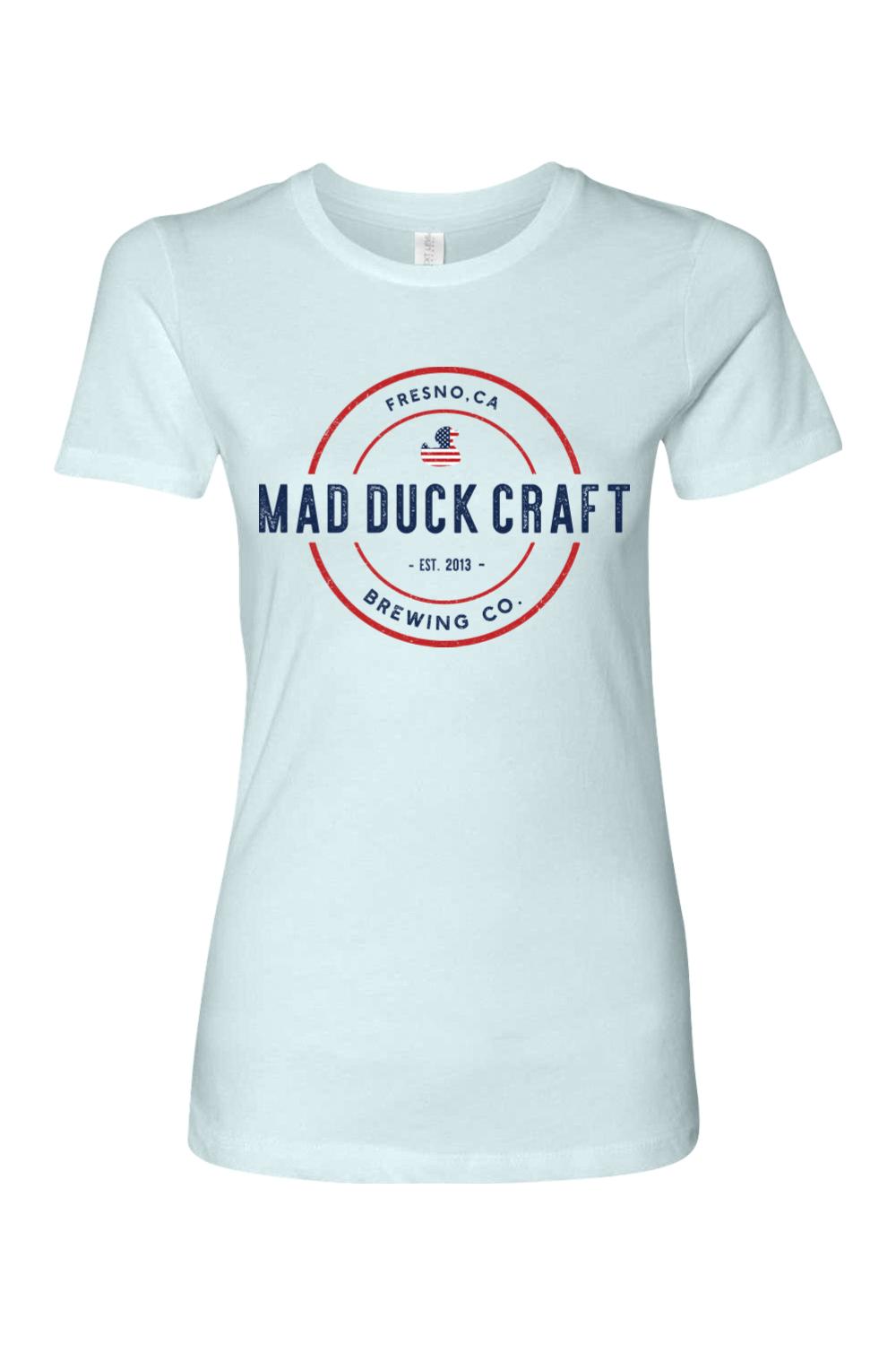 Light blue women's cotton t-shirt featuring a red, white, and blue Mad Duck Craft Brewing Co. logo on the front.