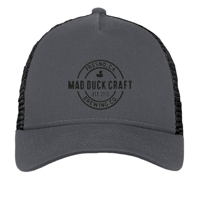 Grey 5-panel New Era trucker cap with black mesh back and embroidered Mad Duck Craft Brewing logo on the front.