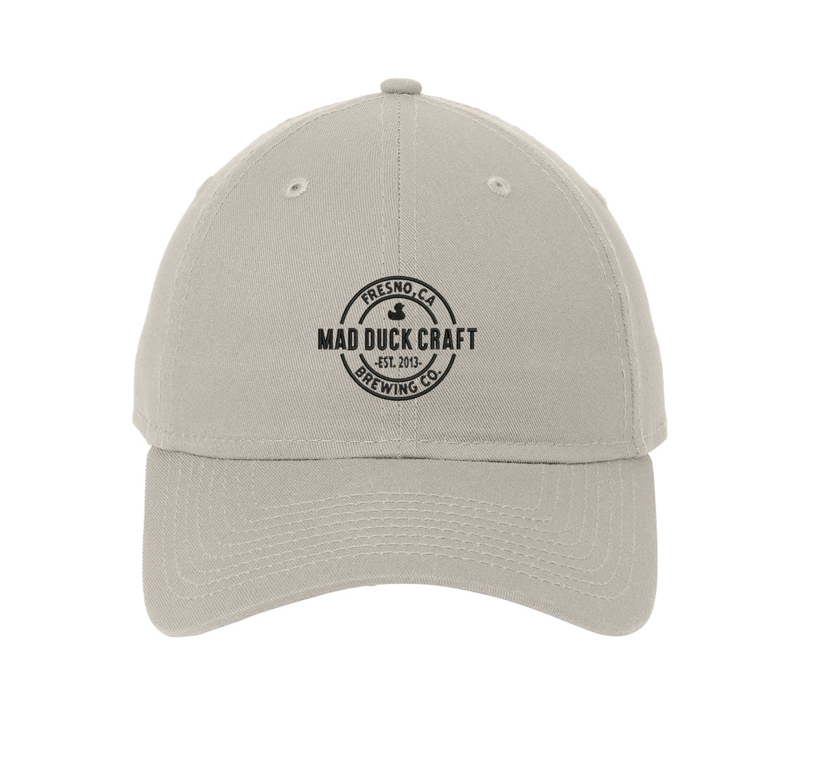 Light grey unstructured cotton dad cap with black Mad Duck Craft Brewing logo embroidered on the front.